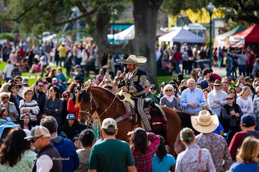 Image of Soloist Manuel Enrique singing while riding a horse. - Photo by George L. Westlund