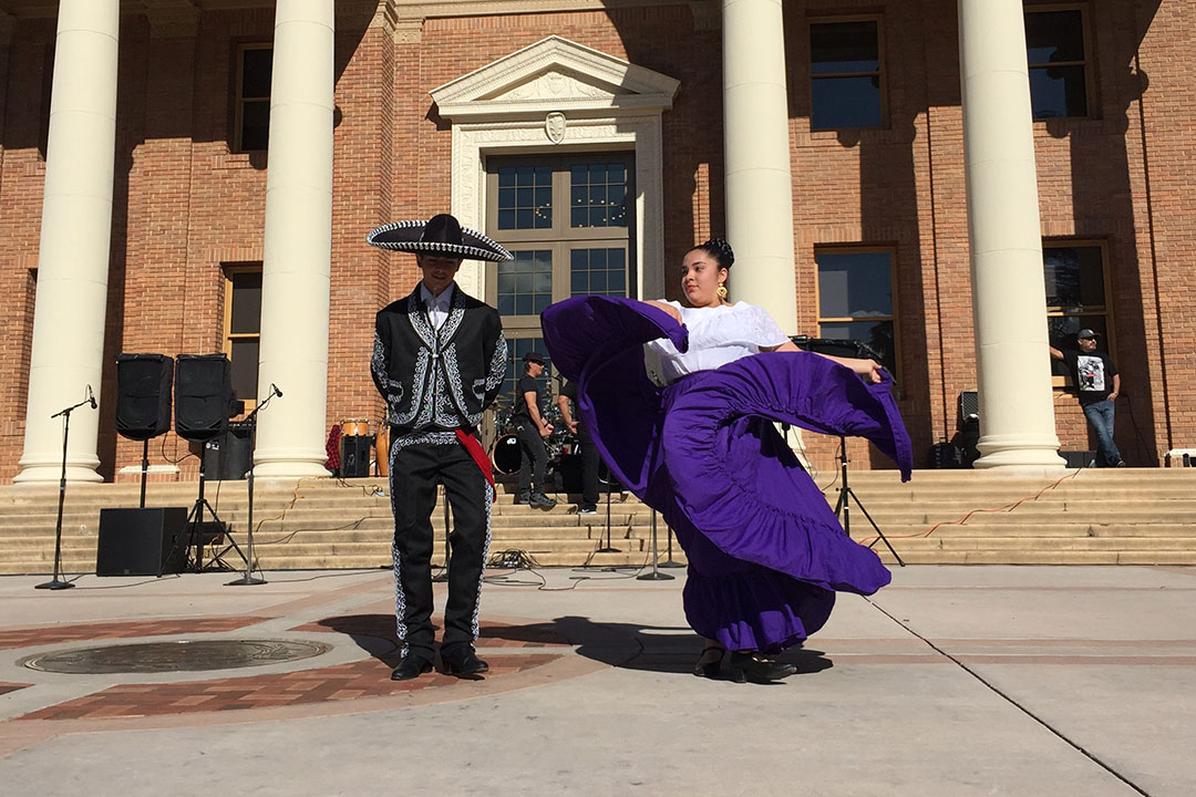 Image of two Folkloric Dancers in traditional garb, dancing in front of Atascadero City Hall - Photo by Rick Evans