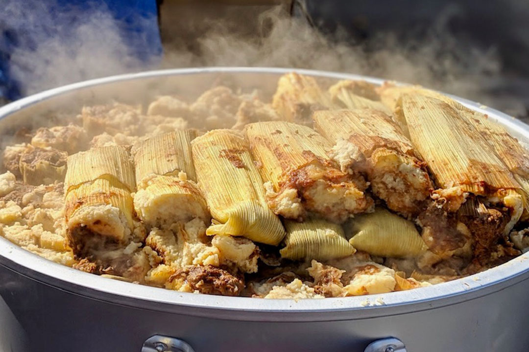 Photo of steaming tamales in pots